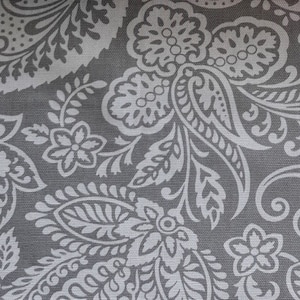 May include: A gray fabric with a white paisley pattern. The pattern features intricate swirls and floral designs.