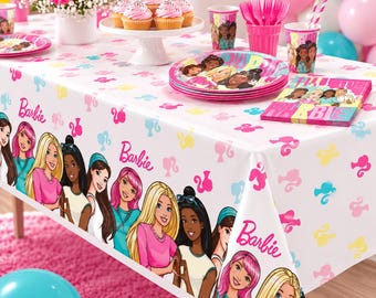 May include: A white plastic tablecloth featuring a repeating pattern of pink, yellow, and blue Barbie silhouettes and the Barbie logo. The border displays a colorful illustration of diverse Barbie characters, matching the plates, cups, and napkins.