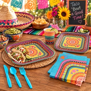 May include: A set of party tableware featuring square plates, cups, and napkins with vibrant, multi-colored geometric and floral patterns. The set includes bright blue plastic cutlery, a straw sombrero, and bowls filled with tacos, guacamole, and chips.