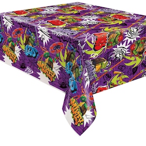 May include: Purple plastic tablecloth with a Teenage Mutant Ninja Turtles theme. The tablecloth features a graffiti-style design with the turtles, their names, and other related imagery.