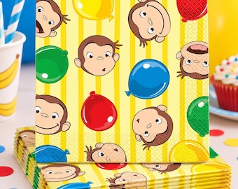 May include: A stack of square paper napkins featuring a repeating pattern of cartoon monkey faces and colorful balloons in red, blue, green, and yellow against a background of vertical yellow stripes. The napkins have a textured, embossed surface.