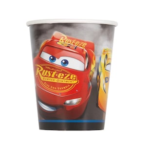 May include: A paper cup featuring a red race car with the text "Rust-eze" and "Bumper Ointment". The cup has a white rim and a black base, with a smoky background and a yellow race car.