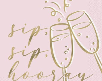 May include: Pink paper napkins with gold foil lettering that reads "sip, sip, hooray" and a gold foil illustration of two champagne flutes clinking together.