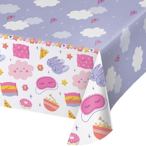 May include: A white tablecloth with a repeating pattern of clouds, hearts, and sleep-themed illustrations. The border features stars and colorful shapes. The design includes pink pillows, donuts, and bunny slippers.
