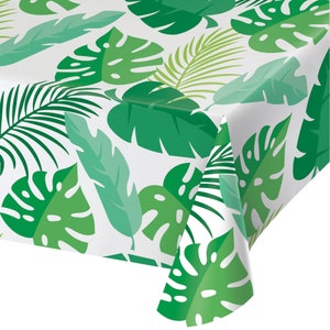 May include: White tablecloth with a vibrant green tropical leaf pattern. The design features various leaf shapes and shades of green, creating a lush, botanical theme. Perfect for a party or event.