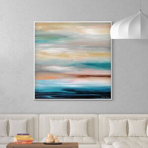 May include: A white sectional sofa with a wooden coffee table and a painting of an abstract seascape above it. The painting features shades of blue, green, and brown.