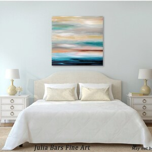 May include: Abstract painting with horizontal brushstrokes in shades of blue, green, brown, and white. The painting is hanging above a white bed with a white headboard and white bedding. Two white nightstands with drawers are on either side of the bed.