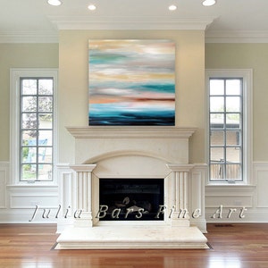 May include: Abstract painting with shades of blue, teal, brown, and white. The painting is hanging above a white marble fireplace in a living room.