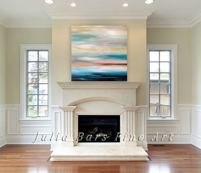 May include: Abstract painting with shades of blue, teal, brown, and white. The painting is hanging above a white marble fireplace in a living room.