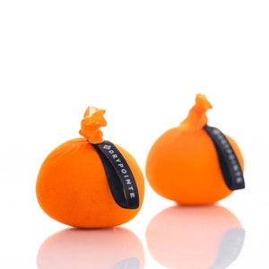 May include: Two orange fabric pouches with black drawstrings. The pouch on the left has a black label that says "DRYPOINTE".