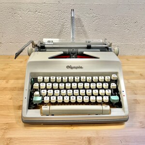 1965 Olympia SM9 Portable Typewriter with Case, New 2-Color Ribbon, Owner's Manual