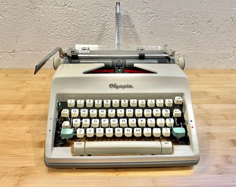 1965 Olympia SM9 Portable Typewriter with Case, New 2-Color Ribbon, Owner's Manual