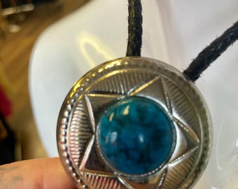 Vintage silver tone concho with turquoise like stone .