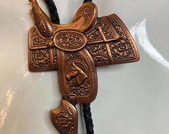 1950s pure copper rare saddle motif bolo tie with floral and equestrian theme
