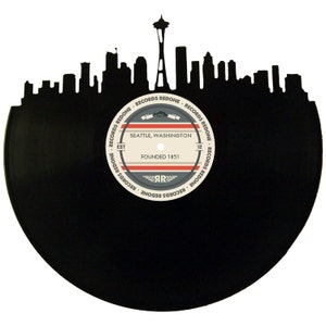 May include: Black vinyl record with a silhouette of the Seattle skyline, including the Space Needle, and a label that reads "Records Redone, Seattle, Washington, Founded 1851".