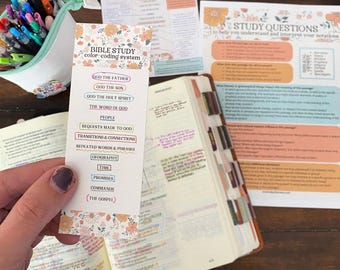 May include: A colorful bookmark with a floral design and a list of Bible study color-coding categories. The categories include God the Father, God the Son, God the Holy Spirit, The Word of God, People, Requests Made to God, Transitions & Connections, Repeated Words & Phrases, Geography, Time, Promises, Commands, and The Gospel.