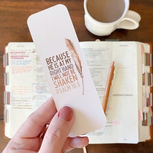 May include: A white bookmark with brown feathers and the text "BECAUSE HE IS AT MY RIGHT HAND I WILL NOT BE SHAKEN PSALM 16:8".