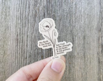 May include: A black and white line drawing of a flower with the text "My flesh & my heart may fail, but God is the strength of my heart & my portion forever. Ps. 73:26"