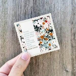 May include: A white sticker with a floral pattern and a quote from Psalm 119:165. The quote reads: "Great peace have those who love your law; nothing can make them stumble."