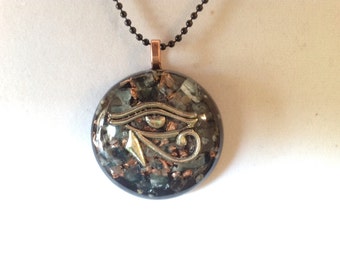 Orgone ASG Eye of Horus pendant with Green Calcite,  Rhodizite, 1.5 in round, 1/2 in thick