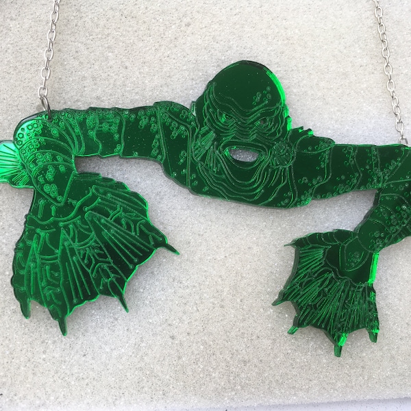 a huge green mirror 'CREATURE from the BLACK LAGOON' statement necklace