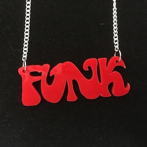 May include: A red acrylic necklace with the word "FUNK" in a retro font.