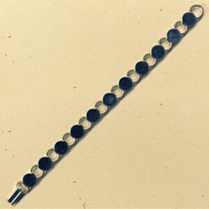 Pode incluir: Um bracelete de prata com uma corrente feita de círculos ligados. Os círculos são planos e têm um acabamento liso e polido.