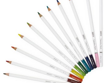 May include: A set of 12 colored pencils with white barrels and colored tips. The pencils are arranged in a fan shape with the colored tips facing outward. The pencils are labeled with the brand name "DUVO" and the words "Zimmerman Pencils". The colors of the pencils are: Raven Black, Cocoa Bean, Toffee Apple,  Green Apple,  Jade Green, Teal Blue, Alicia Vikies,  The Dua, White Cotton,  and  Zimmerman Pencils.