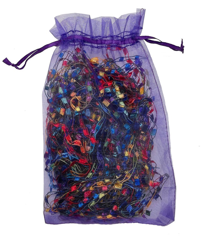 May include: A purple mesh bag filled with colorful, glittery ribbon scraps.