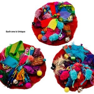 May include: Three red felt circles with colorful fabric scraps, beads, and embellishments. Each one is unique.