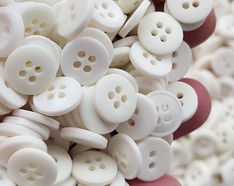 1 pound of assorted white buttons All are round, under half an inch, some 2 hole and some 4 hole