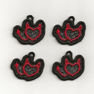 May include: Four black and red embroidered patches with a heart and devil horns design. The patches are made of a delicate lace material.