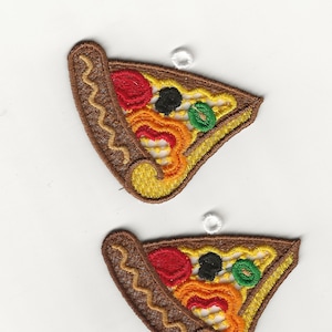 May include: Two embroidered felt pizza slices with a brown crust, red and orange peppers, green olives, and black olives. The slices have a white loop for hanging.