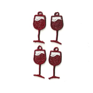 May include: Four red wine glass embroidery patches with white accents. The patches are approximately 1 inch in diameter.