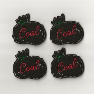 May include: Four black felt Christmas stocking ornaments with green trim and red embroidered "Coal" text.