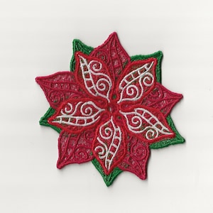 Può includere: Un fiore di stella di Natale rosso e bianco con foglie verdi, ricamato con dettagli intricati. Il fiore è una decorazione natalizia tradizionale.