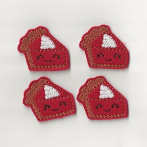 May include: Four embroidered patches shaped like pie slices. Each slice is red with a brown crust and a dollop of white whipped cream. The pie slices have smiling faces with black stitched details.