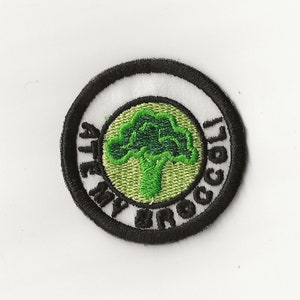 May include: A white and black circular embroidered patch with the text "I ate my broccoli" and a green broccoli graphic.