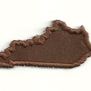 May include: Brown felt outline of the state of Kentucky.