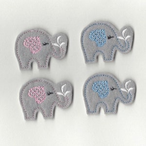 May include: Four felt appliques of elephants in gray with pink and blue embroidered details. The elephants have white embroidered leaves coming out of their trunks.