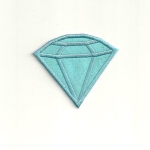 Può includere: Una toppa a forma di diamante blu chiaro con cuciture bianche.