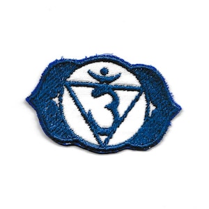 May include: Blue embroidered patch featuring a white Om symbol within a triangle. The symbol is encircled by a blue circle with a white border.