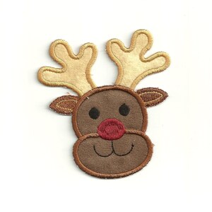 May include: A brown reindeer face with a red nose and black eyes. The reindeer has large, tan antlers.