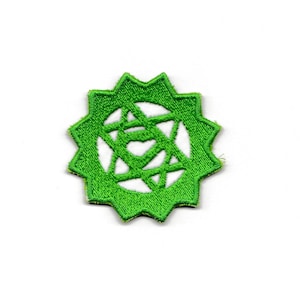 May include: Green embroidered patch with a white starburst design. The patch has a jagged edge.
