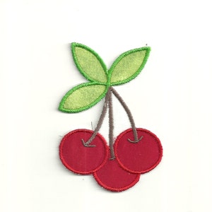 May include: Three red cherries with green leaves and brown stems. The cherries are embroidered on a white fabric.