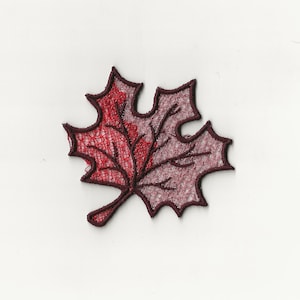 May include: A red and brown embroidered maple leaf patch.