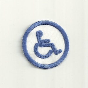 May include: Blue and white embroidered patch with a wheelchair accessibility symbol.