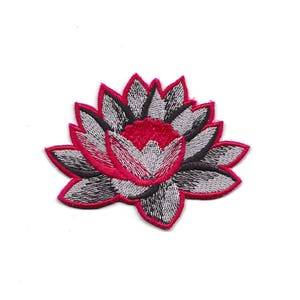 May include: An embroidered lotus flower patch in pink and grey. The flower has a detailed design with multiple layers of petals.