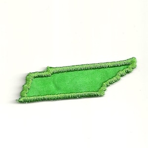 May include: Green felt outline of the state of Tennessee, with a green felt interior. The outline is stitched with a dark green thread.