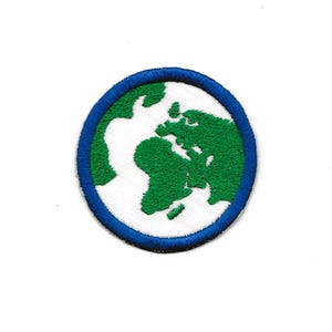 May include: A white embroidered patch with a green outline of the Earth on a blue circle.